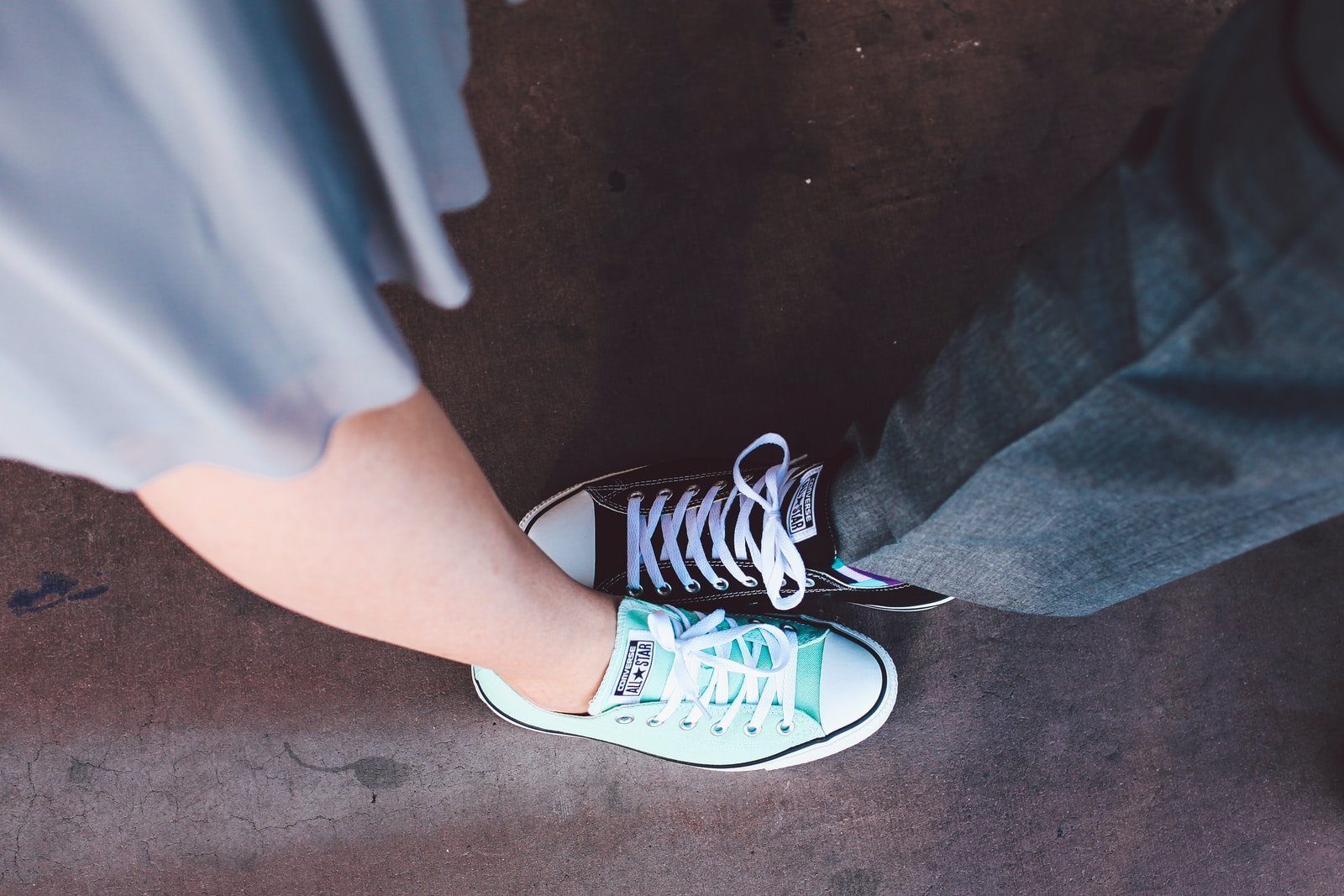 person wearing teal and white Converse All-Star low-top