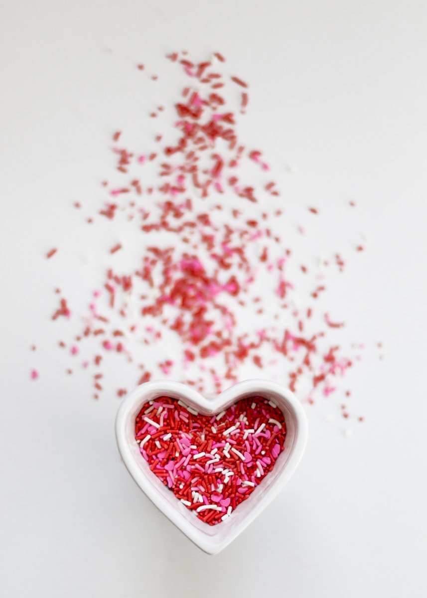 selective focus photo ofsprinkles in heart ceramic bowl