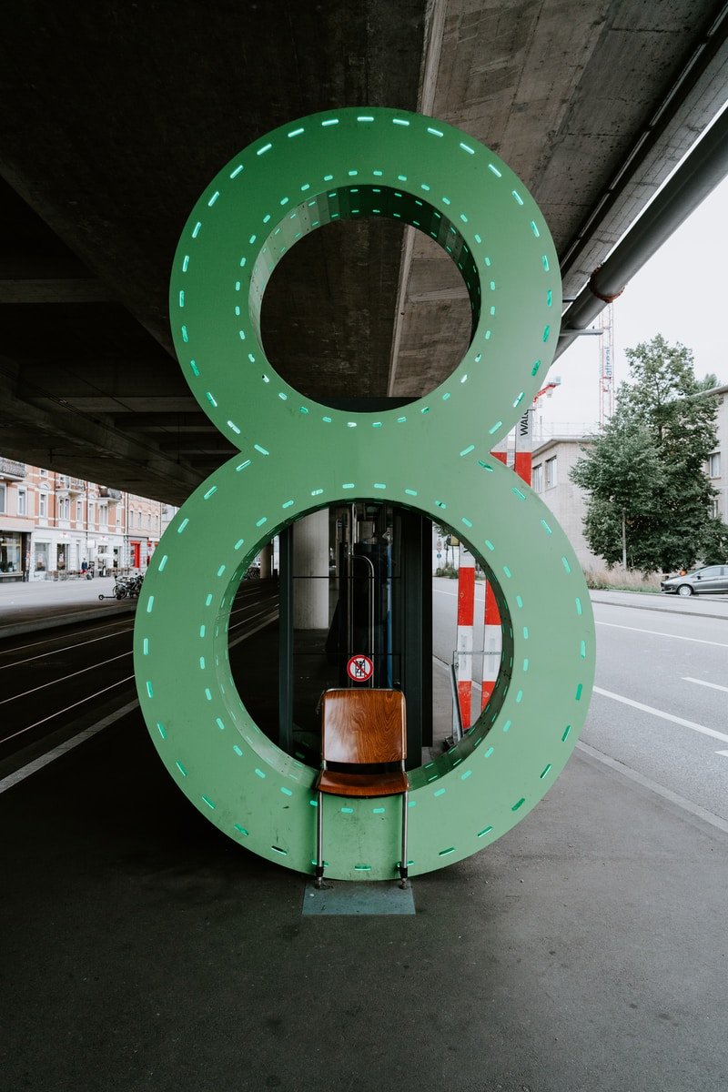 empty chair in front of green number 8 sign